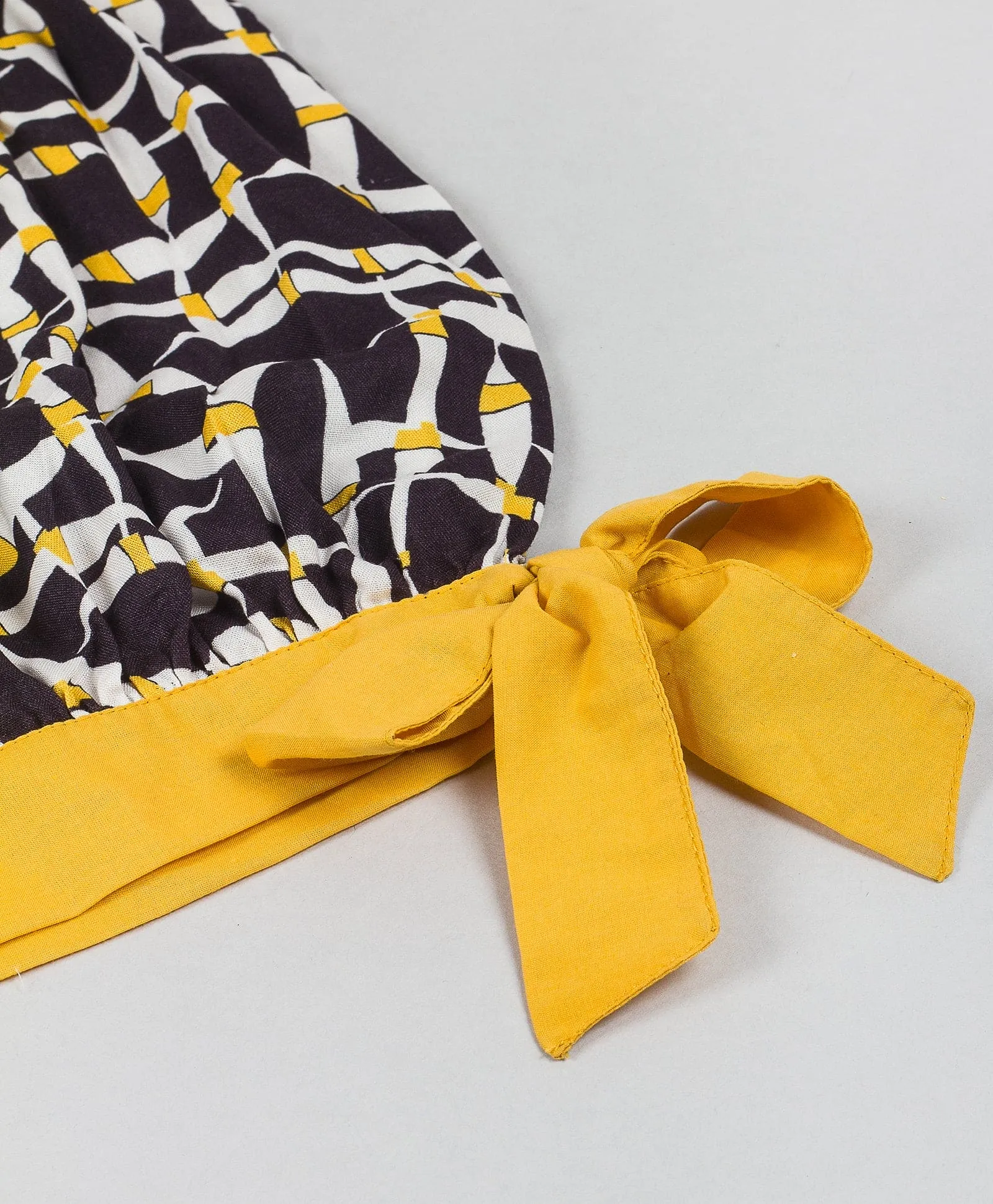 Geometric print top with yellow tie up at waist-Black